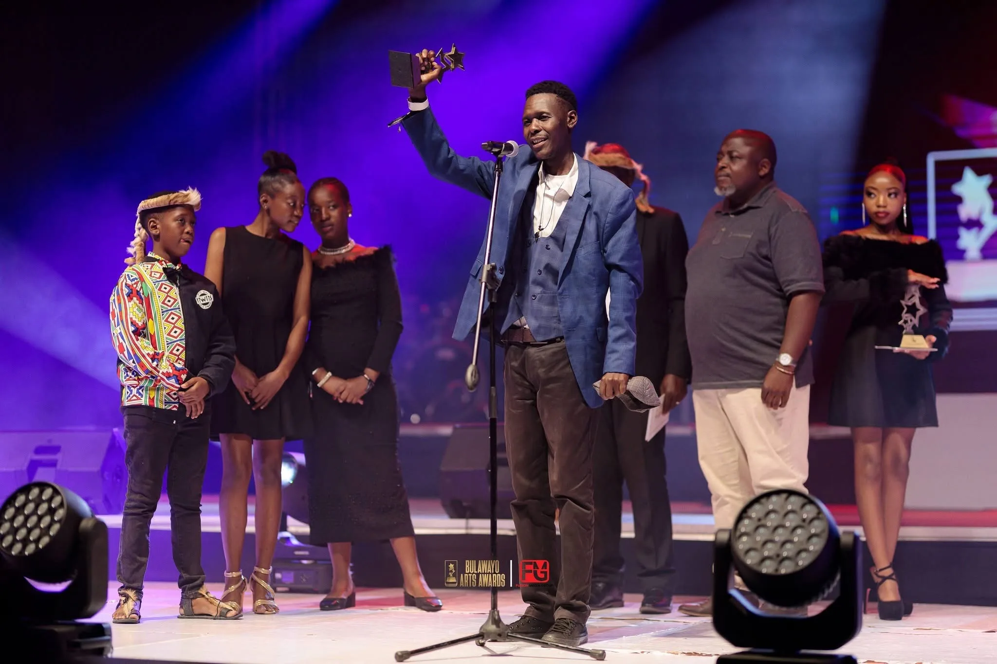 An award being accepted on stage at the Bulawayo Arts Awards
