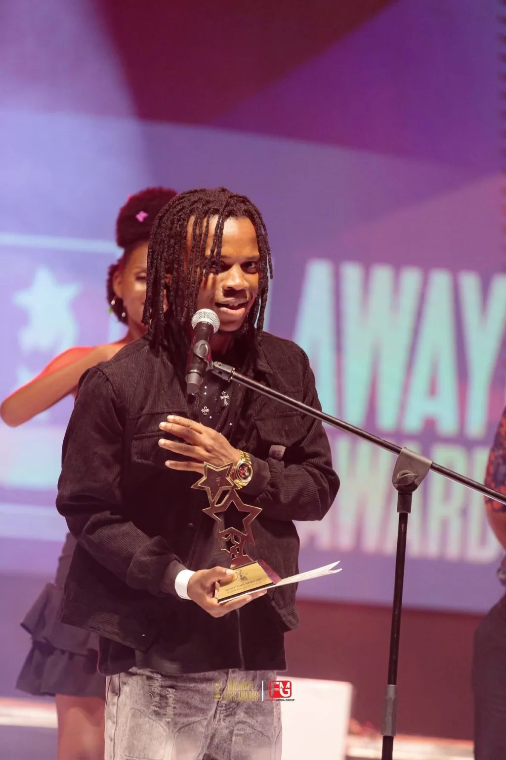A winner celebrating on stage