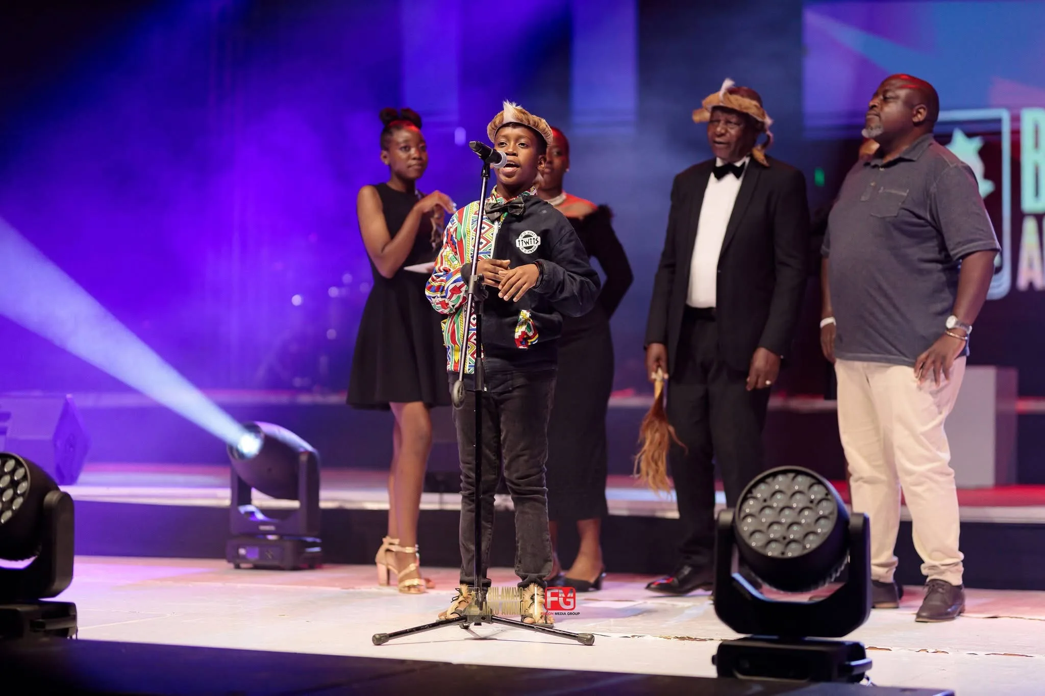 A group accepting an award on stage